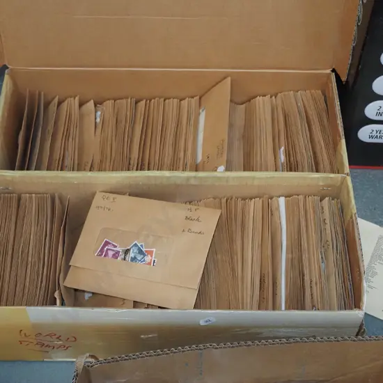 box of envelopes and world stamps