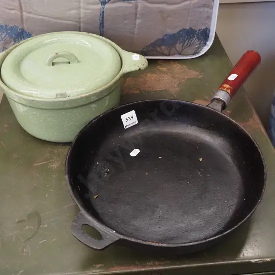 green speckled cast iron lidded casserole, wooden handled cast iron frying pan