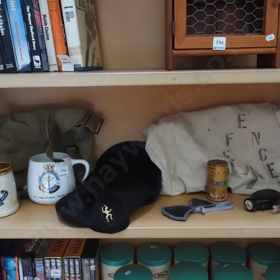 shelf; military items, berets, bag, coffee cups etc