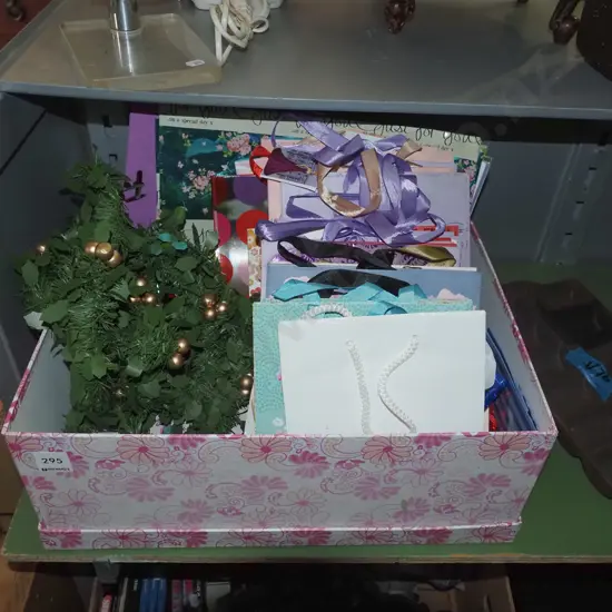 box of gift bags, stickers, craft paper, faux mistletoe