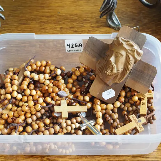 wooden rosaries and carved wooden figurine