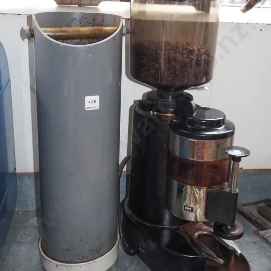 unbranded commercial coffee grinder with beans and a tap out