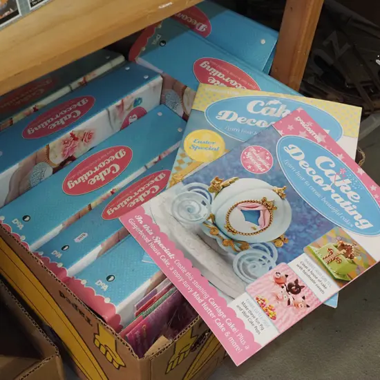 box of cake decorating magazines and folders