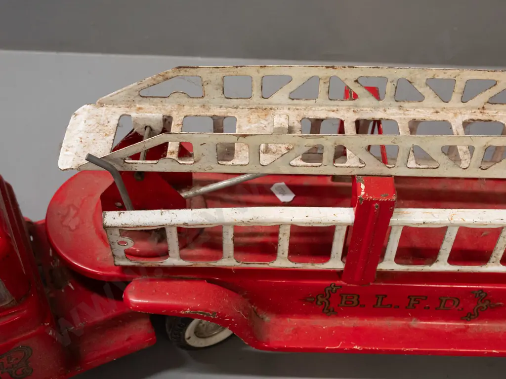 large tin toy vehicle - Buddy L "BLFD" fire engine with spring suspension and ladder - missing cab light and some Image 1++