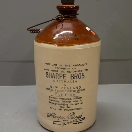 stoneware crock with wire handle and original bakelite stopper - marked Sharpe Bros. Australia and New Zealand - some