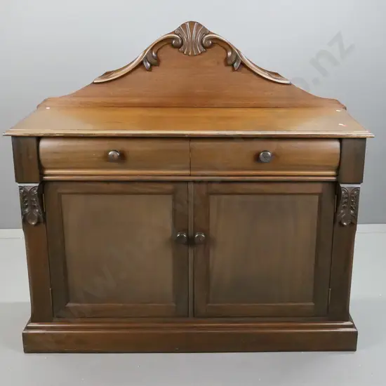 reproduction mahogany veneer carved-back sideboard w/ 2 shaped drawers, 2 panelled doors, wooden knobs - one drawer with