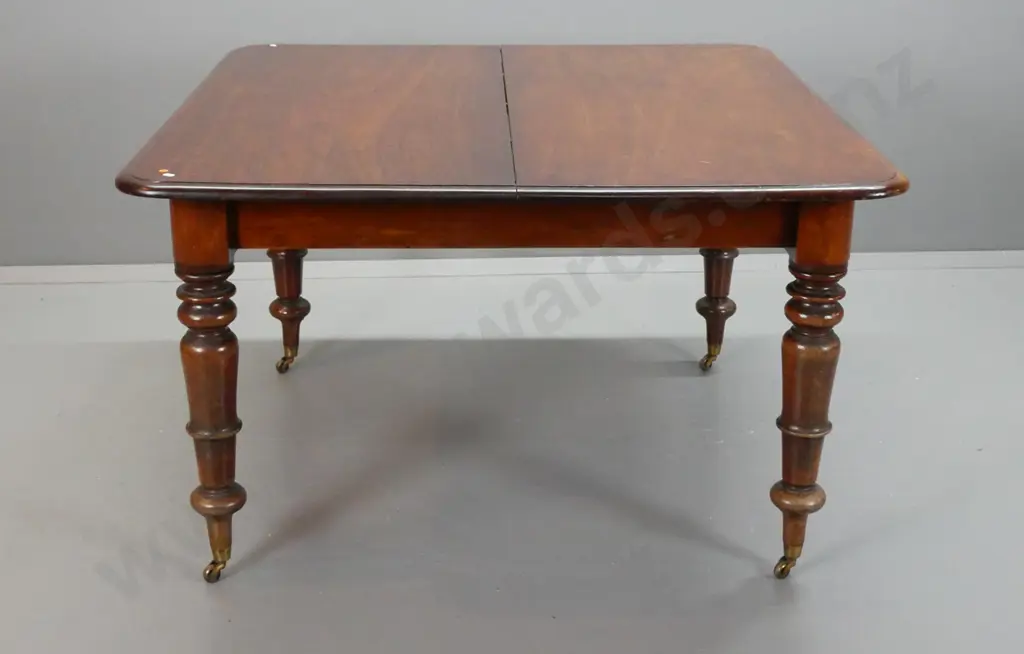 early Victorian mahogany draw-leaf dining table with turned legs on brass cup casters - no leaves, two ends not closing Image 1++