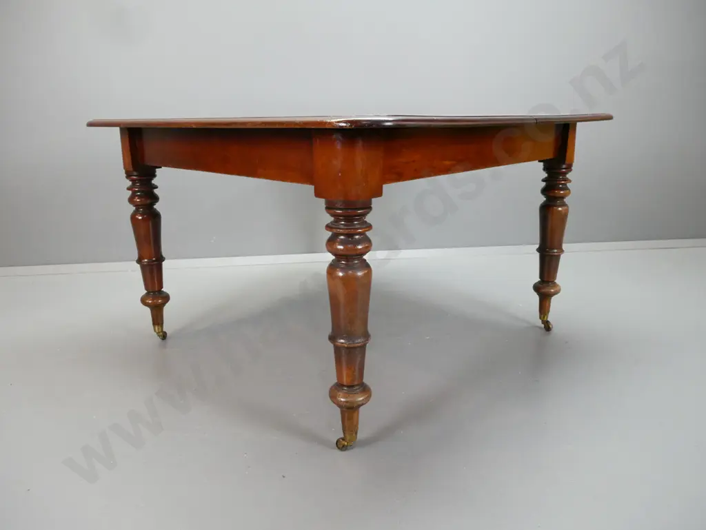 early Victorian mahogany draw-leaf dining table with turned legs on brass cup casters - no leaves, two ends not closing Image 1++