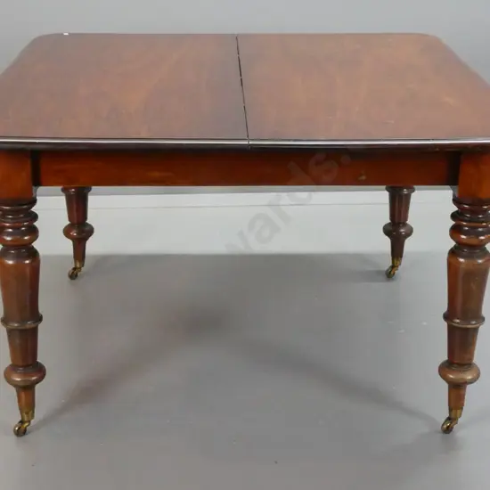 early Victorian mahogany draw-leaf dining table with turned legs on brass cup casters - no leaves, two ends not closing