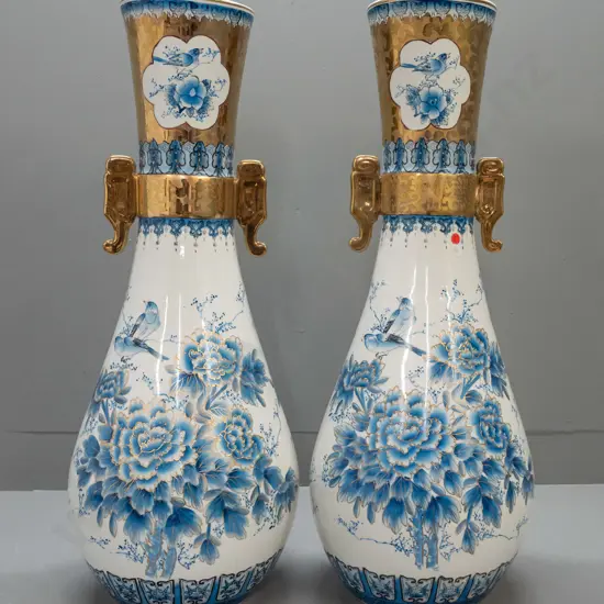 pair of large Chinese blue and white floor vases - floral and bird panels raised gilt edging, gilt hand and lug handles