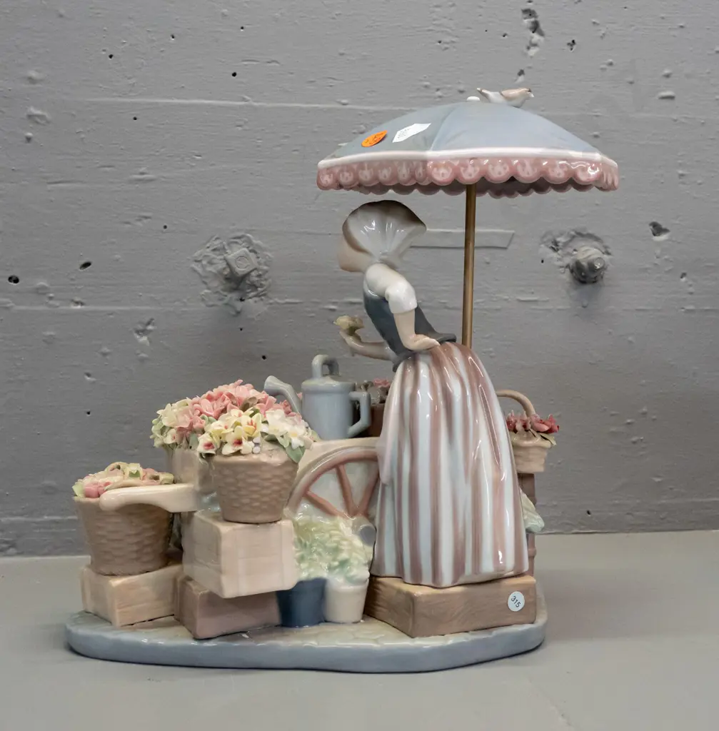 intricate Lladro figure of flower seller with cart and basket of flowers, birds etc. H-265 W-250. Image 1++