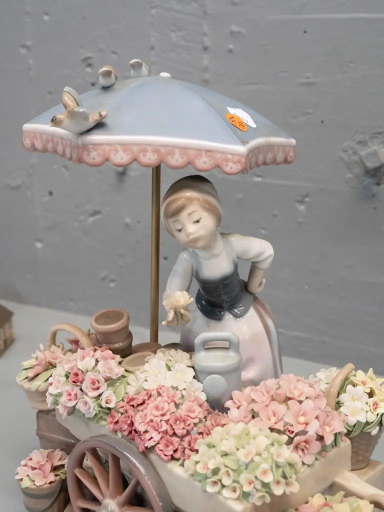 intricate Lladro figure of flower seller with cart and basket of flowers, birds etc. H-265 W-250. Image 1++