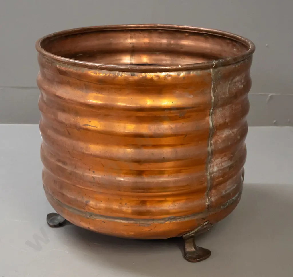 ribbed copper wood bin on 3 copper-plated feet, some dents and wear to painted interior, patched repair in bottom H-340 Image 1++