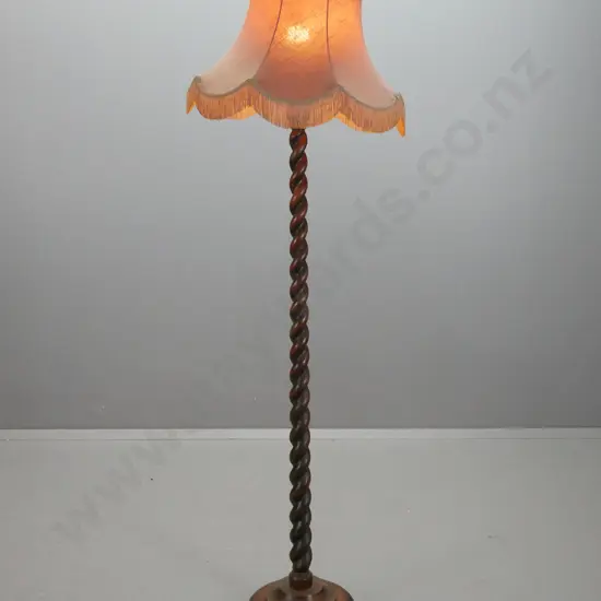 vintage oak standard lamp with Jacobean twist column, circular stepped base on bun feet, with waisted frilled shade -