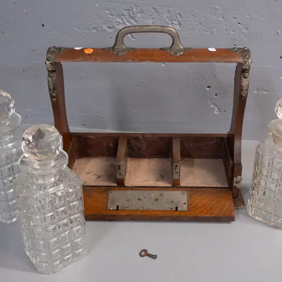 restorer's oak tantalus with 3 decanters with white metal mounts, hinged front panel with working key - 2 stoppers are