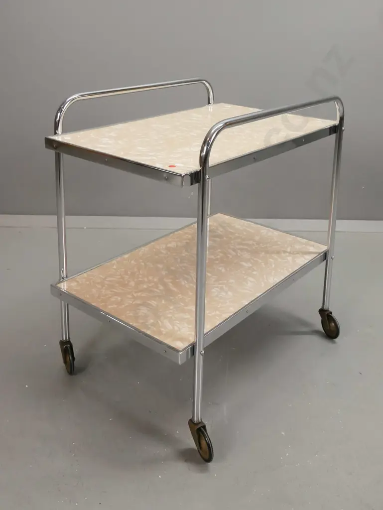 art deco tea trolley with 2 formica shelves on chrome frame on metal casters with rubber rims. Some corrosion to casters Image 1++