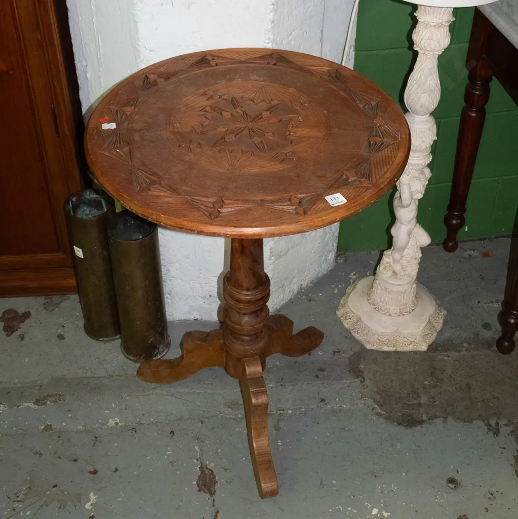 kauri and rimu wine table with geometric-carved circular top on turned column on 3 sweeping legs. Some staining, one leg Image 1++