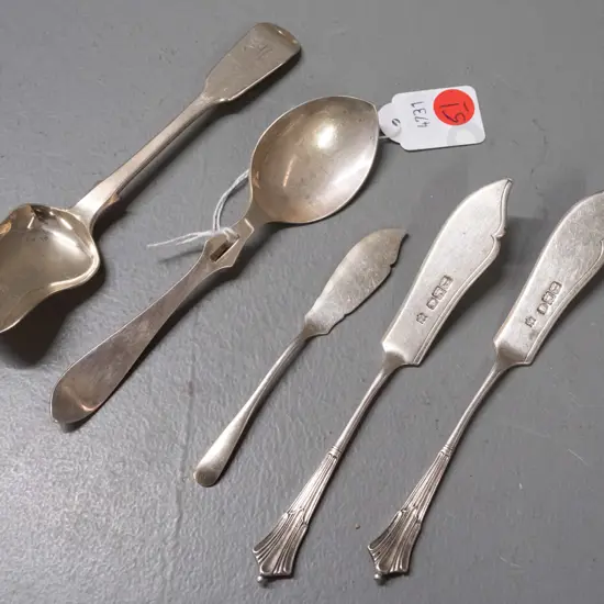 sterling silver butter knives, spoon with notched hook in handle and sugar scoop - all have hallmarks. Scoop is L-150