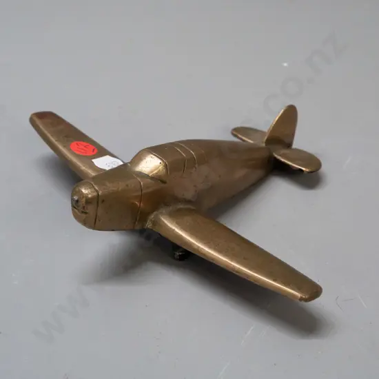 solid cast brass aeroplane model with black painted underside, missing propellor, some pitting and age wear L-160 W-190