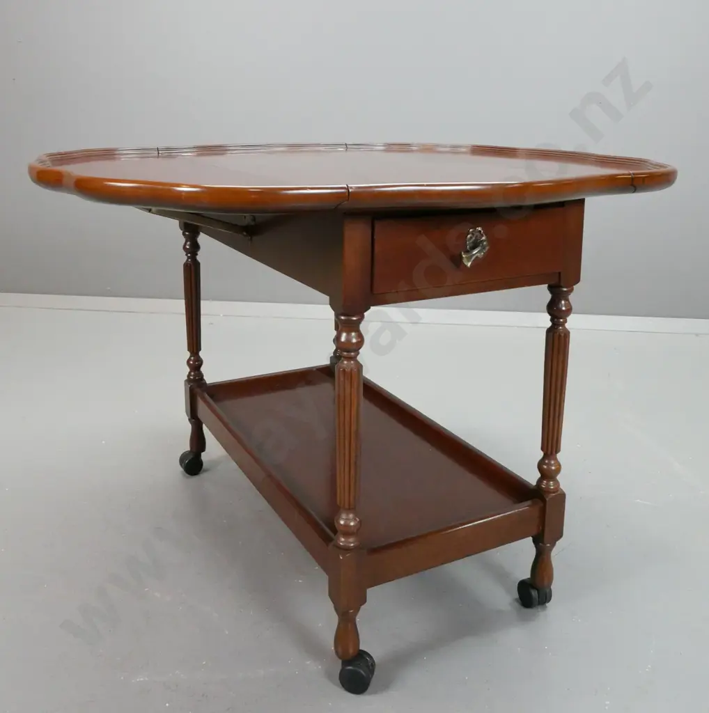 retro drop side tea trolley with serpentine shaped top, fluted turned supports, bottom shelf, on nylon casters - leaves Image 1++