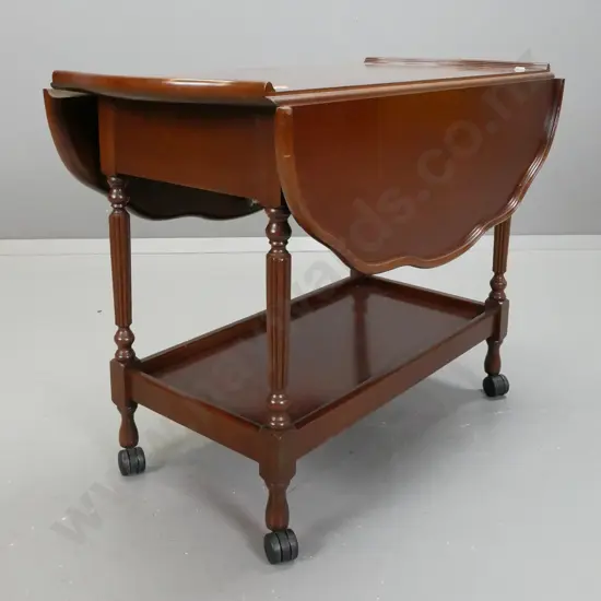 retro drop side tea trolley with serpentine shaped top, fluted turned supports, bottom shelf, on nylon casters - leaves