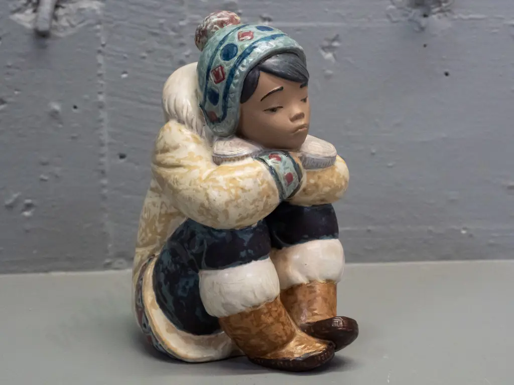 Lladro seated boy in inuit style clothing, marked 1985 on base H-170 Image 1++