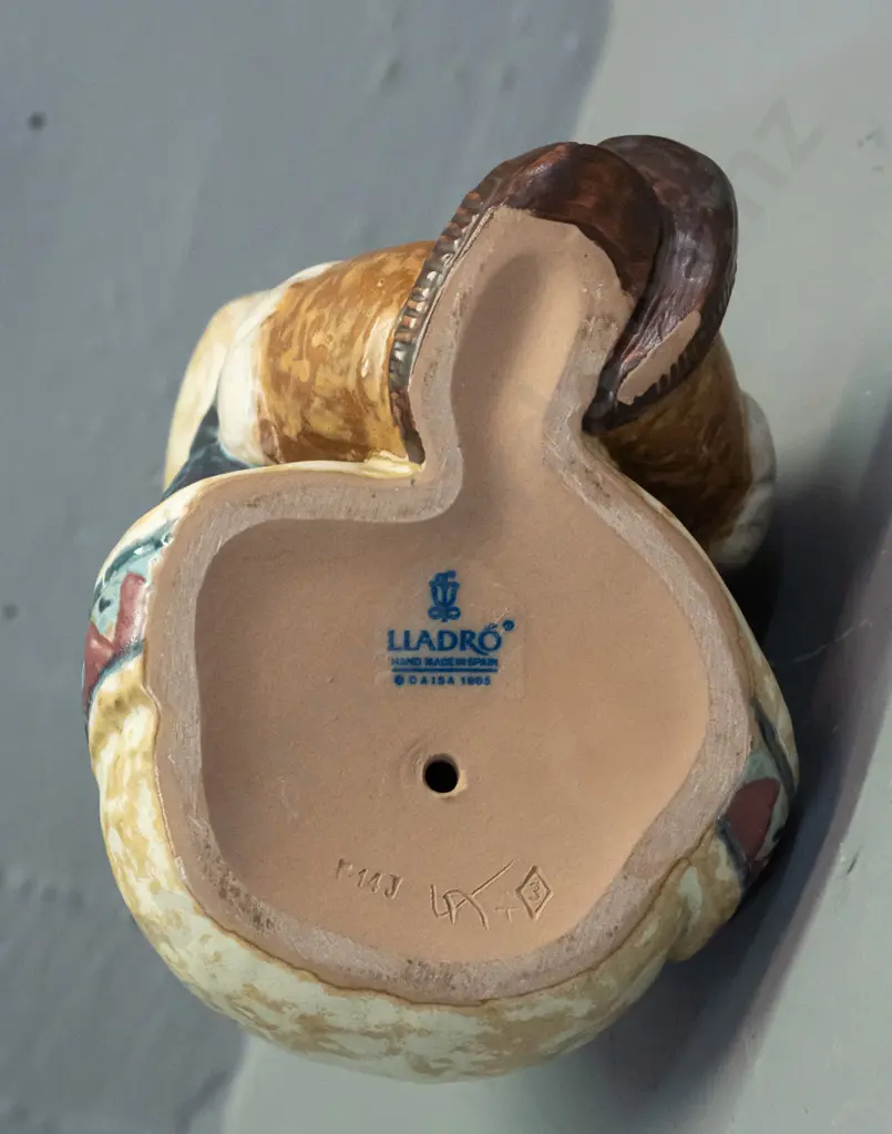 Lladro seated boy in inuit style clothing, marked 1985 on base H-170 Image 1++