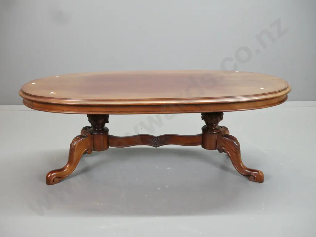 reproduction mahogany coffee table with carved double pedestal base and shaped stretcher rail - top surface has some Image 1++