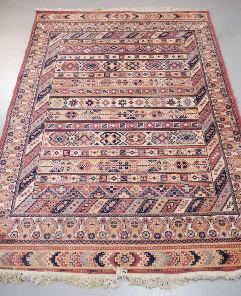 Belgian "Onyx" wool floor rug with tribal style pattern in black, brown and reds - some wear to fringes, minor fading Image 1++