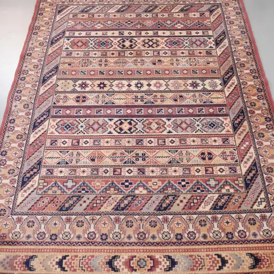 Belgian "Onyx" wool floor rug with tribal style pattern in black, brown and reds - some wear to fringes, minor fading