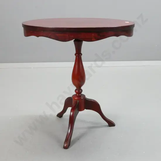 mahogany oval topped wine table with shaped edge, on turned pedestal base on 3 feet - some staining and scratching to