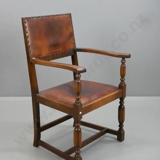vintage arts & crafts style open-armed chair with turned supports, stretcher base, leather upholstered seat and back,