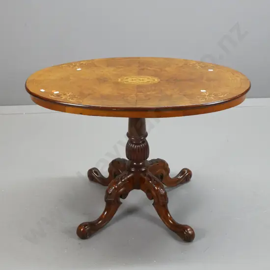 Victorian walnut oval topped side table with veneer top and boxwood stringing and inlay, oval boxwood trophy to centre,