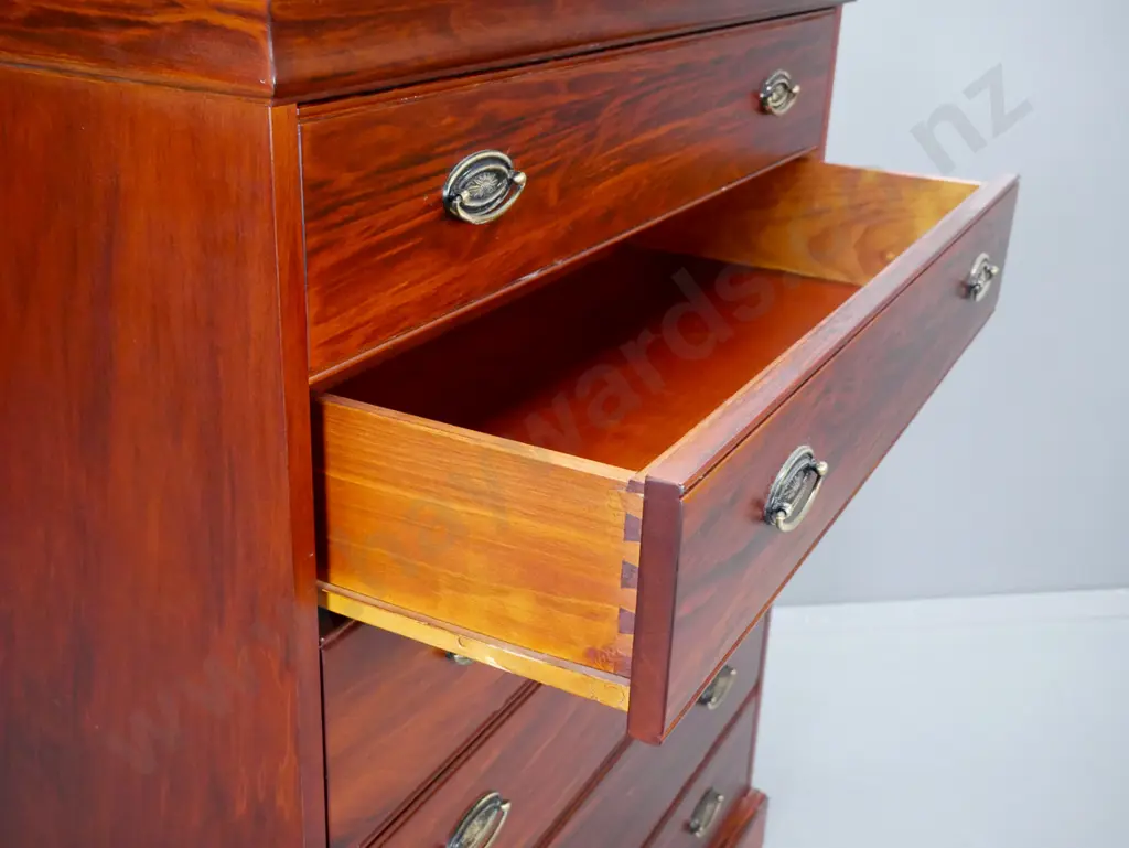 Reproduction 6 long drawer, pacific kauri chest,  with stepped top on shaped plinth, oval brass handles. Image 1++