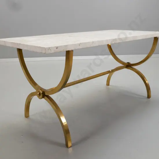 stone or composite stone topped coffee table on brass U-shaped stretcher base. Chip to one corner, base needs tightening