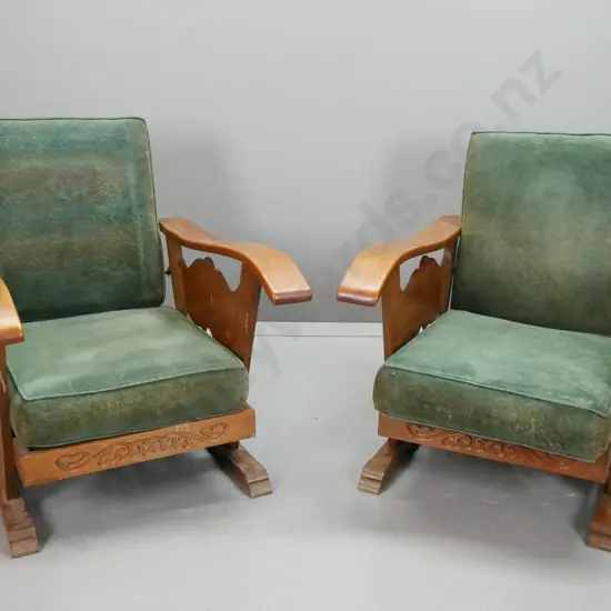 pair of oak Morris style lounge chairs with carved supports and sides, reclining backs with notched adjustment arms,
