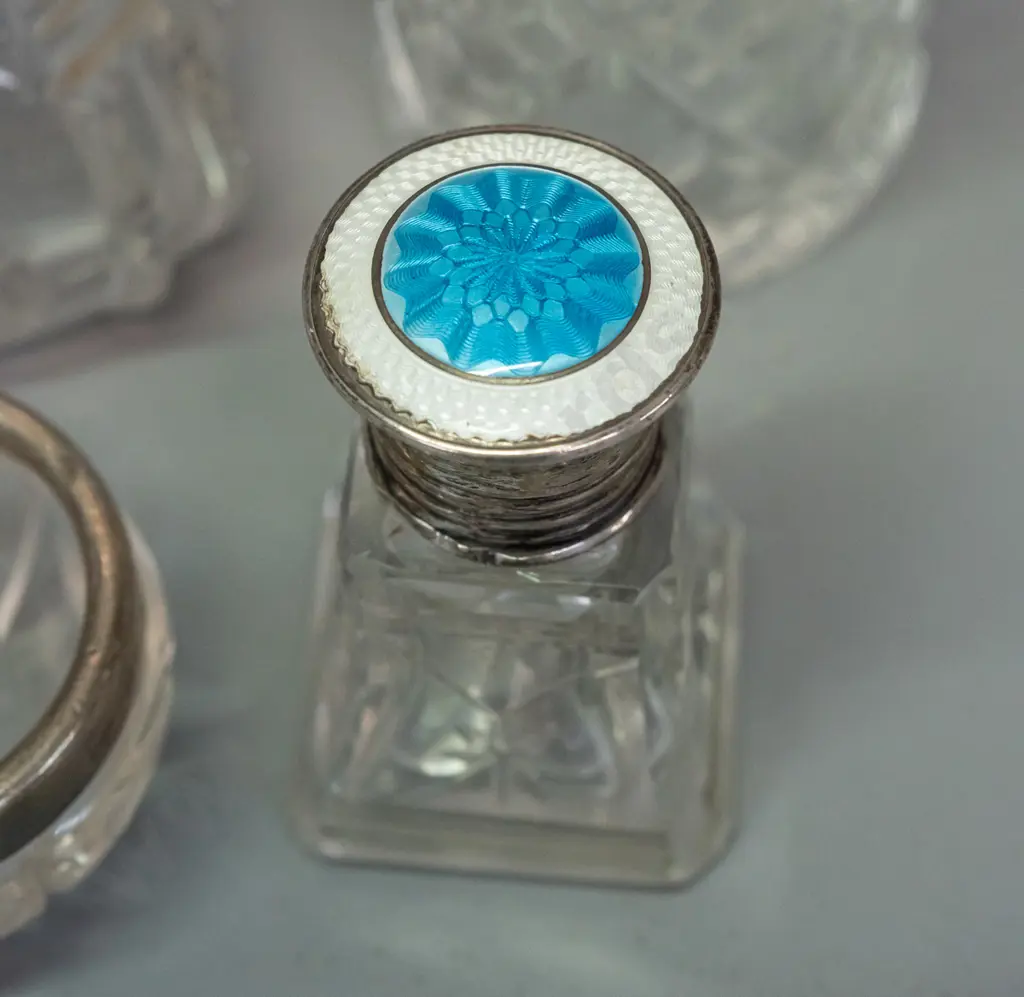 6 vintage scent bottles and a small bowl, 4 w/ sterling silver caps or collars, one enamelled sterling. One missing Image 1++