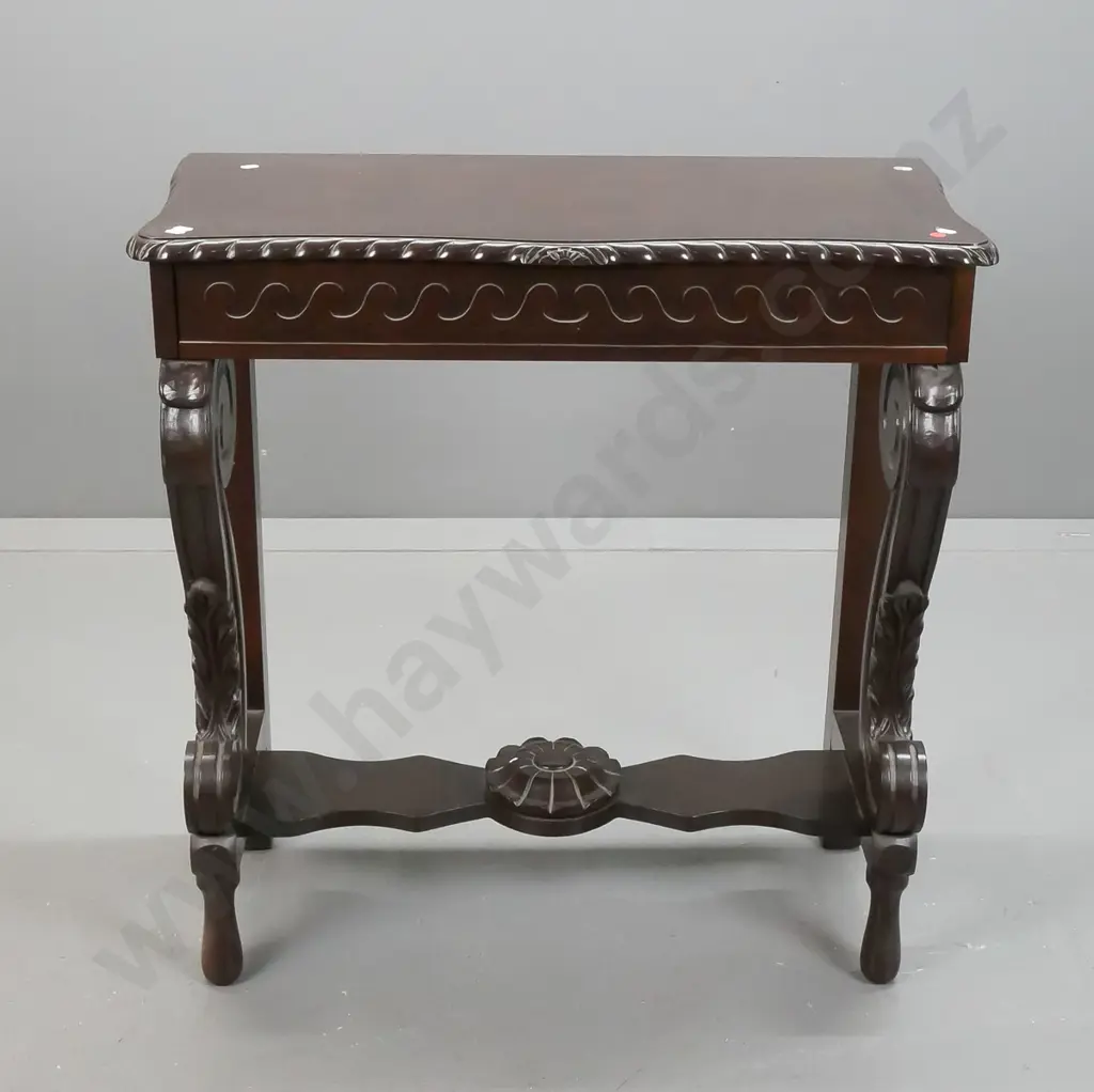 reproduction mahogany console table with shaped edge, scrolling legs to platform base, stylized flower in stretcher, Image 1++
