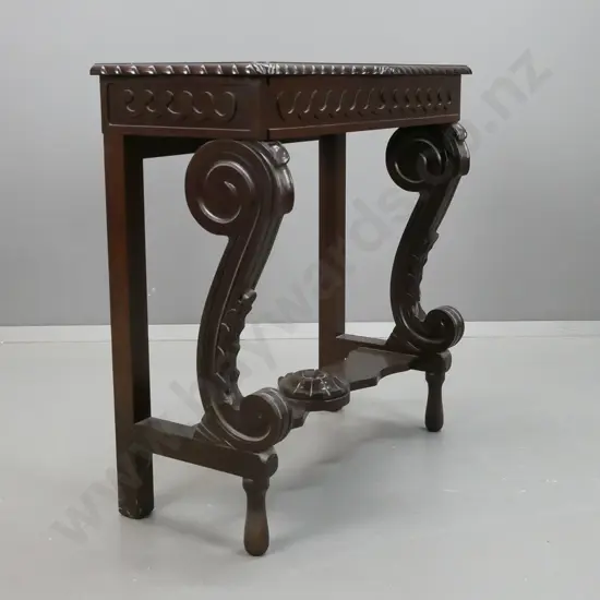 reproduction mahogany console table with shaped edge, scrolling legs to platform base, stylized flower in stretcher,