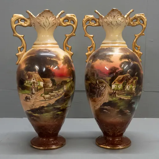 pair of English vases marked "Old England" and "English Make" - cottage scenes with gilt rims and handles -