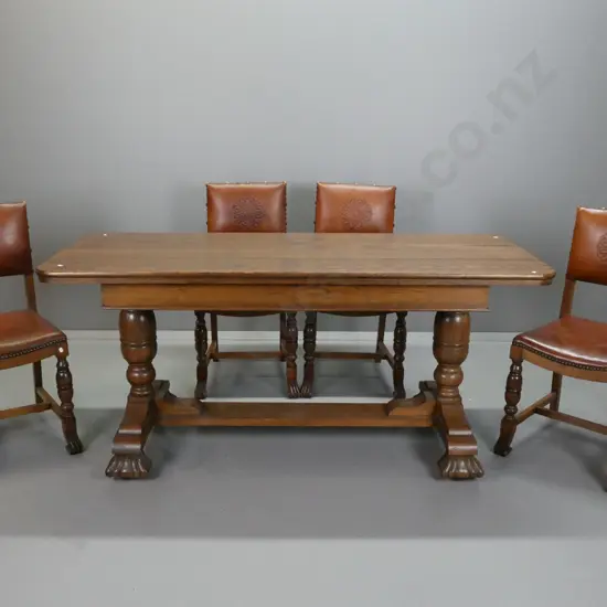 oak extending refectory-based dining table & 4 tooled leather backed chairs, with brass studded edging.