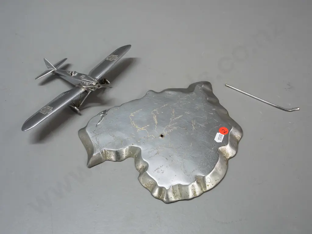 cast metal aeroplane model on heavy roughly cast base in shape of map of Lithuania, engraved with place names. Aeroplane Image 1++