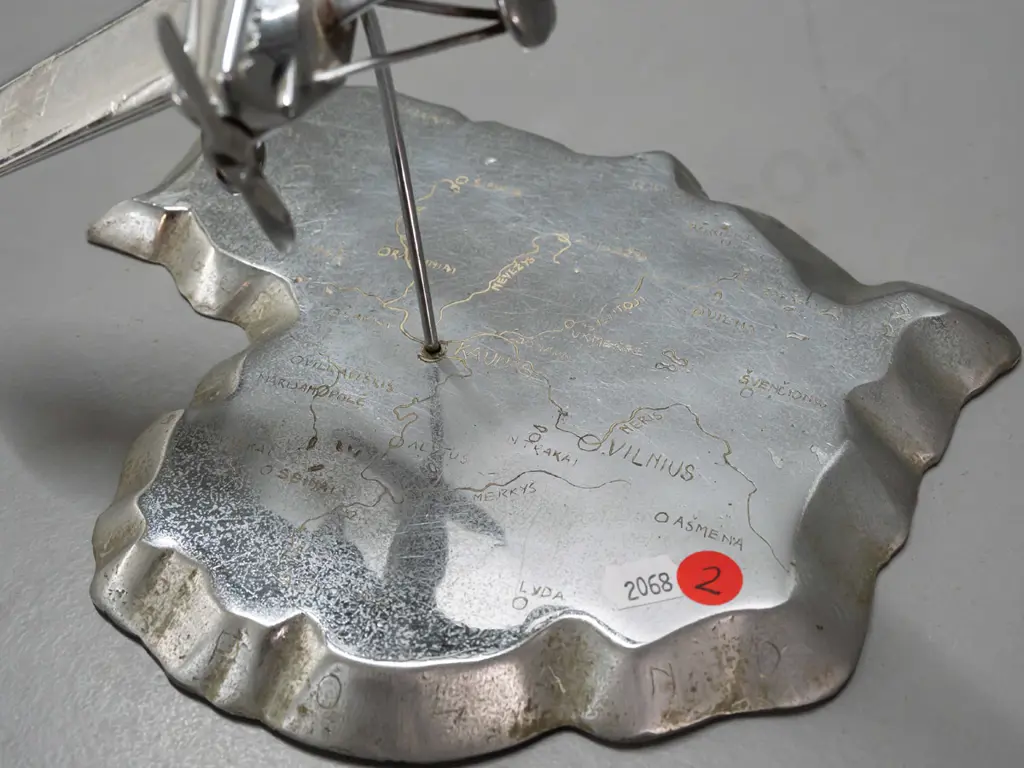 cast metal aeroplane model on heavy roughly cast base in shape of map of Lithuania, engraved with place names. Aeroplane Image 1++