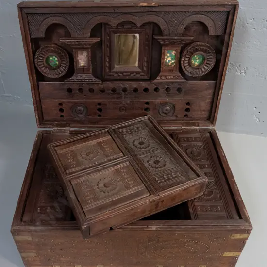 Indian dowry chest with carved hardwood with brass binding, inlaid decoration, swan-neck handles, mirror and glazed