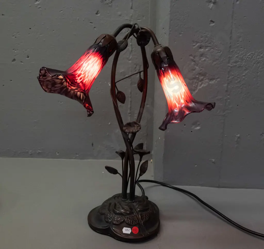 Tiffany style 2-light lily motif table lamp w/ cast metal base, twined foliage stem, purple mottled lustre glass shades Image 1++
