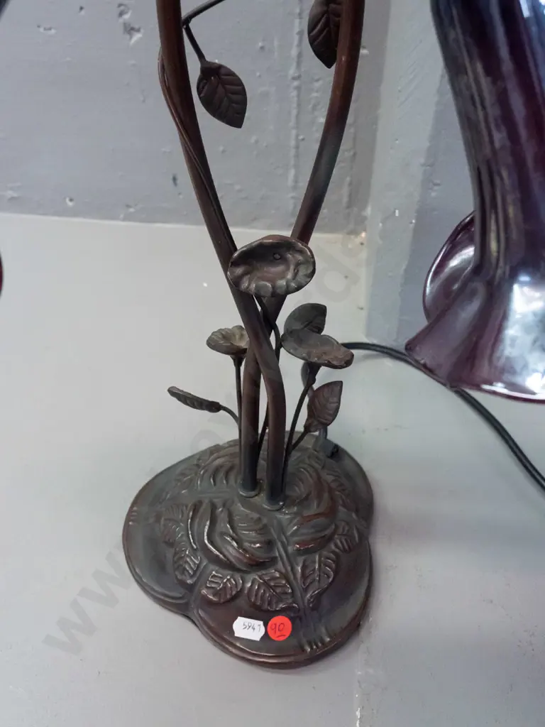 Tiffany style 2-light lily motif table lamp w/ cast metal base, twined foliage stem, purple mottled lustre glass shades Image 1++