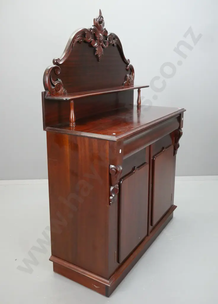 reproduction mahogany carved back chiffonier with shaped shelf over long shaped drawer, 2 doors with shield shape panels Image 1++