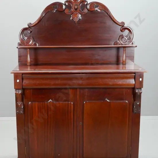 reproduction mahogany carved back chiffonier with shaped shelf over long shaped drawer, 2 doors with shield shape panels