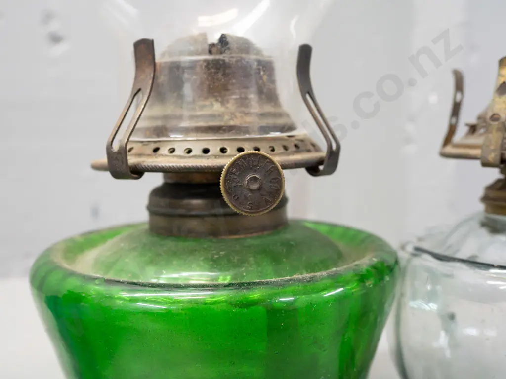 4 glass kerosene lamps, 3 with chimneys, mixed colours - 2 with Miller Co USA mark on wick adjustment knob. Image 1++