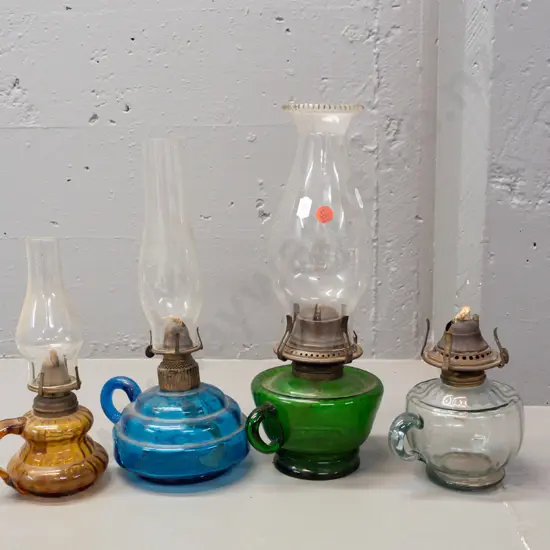 4 glass kerosene lamps, 3 with chimneys, mixed colours - 2 with Miller Co USA mark on wick adjustment knob.